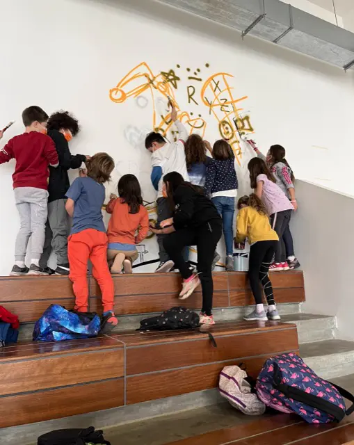Students painting a wall together